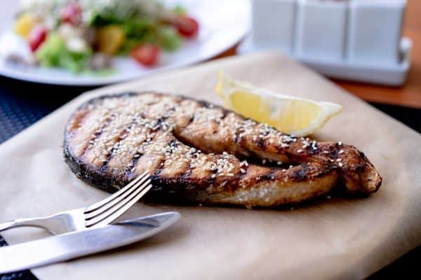 grilled fish with knife and fork in a platter