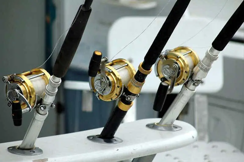 three yellow and black  fishing reels